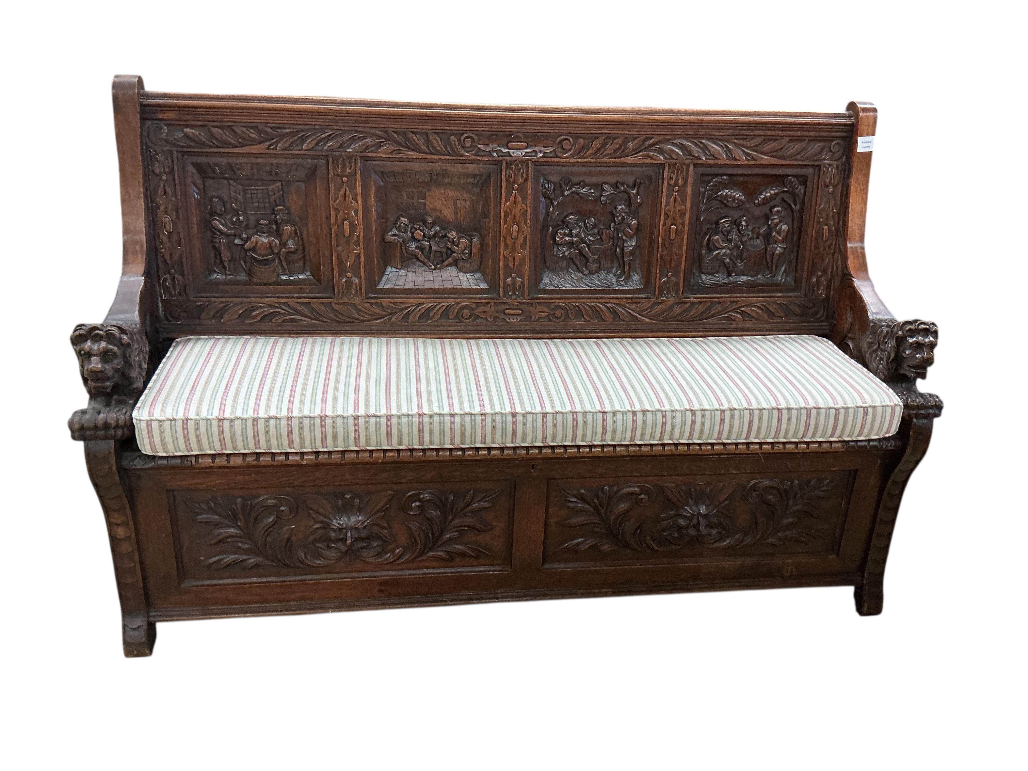 A late 19th century Flemish carved oak settle with hinged box seat, width 160cm, depth 42cm, height 106cm